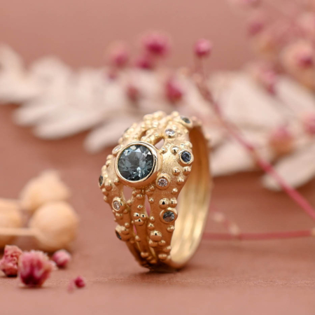 Three strand statement ring with ethical blue sapphire and canada mark diamonds
